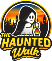 Cartoon ghost in a black cape holding yellow and orange lantern with black city skyline in background with sunset. Text reads "The Haunted Walk" under the ghost.